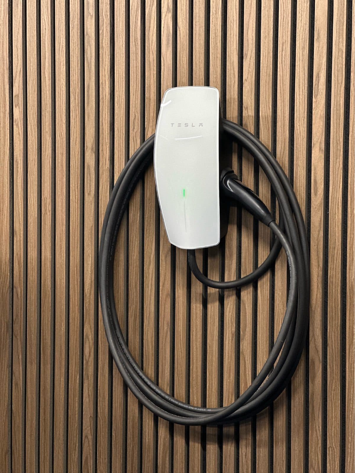 Tesla Gen 3 Wall Connector installed on a timber slat feature wall by Tronic Electrical